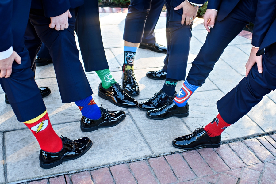 Groomsmen show off their cool super hero socks.